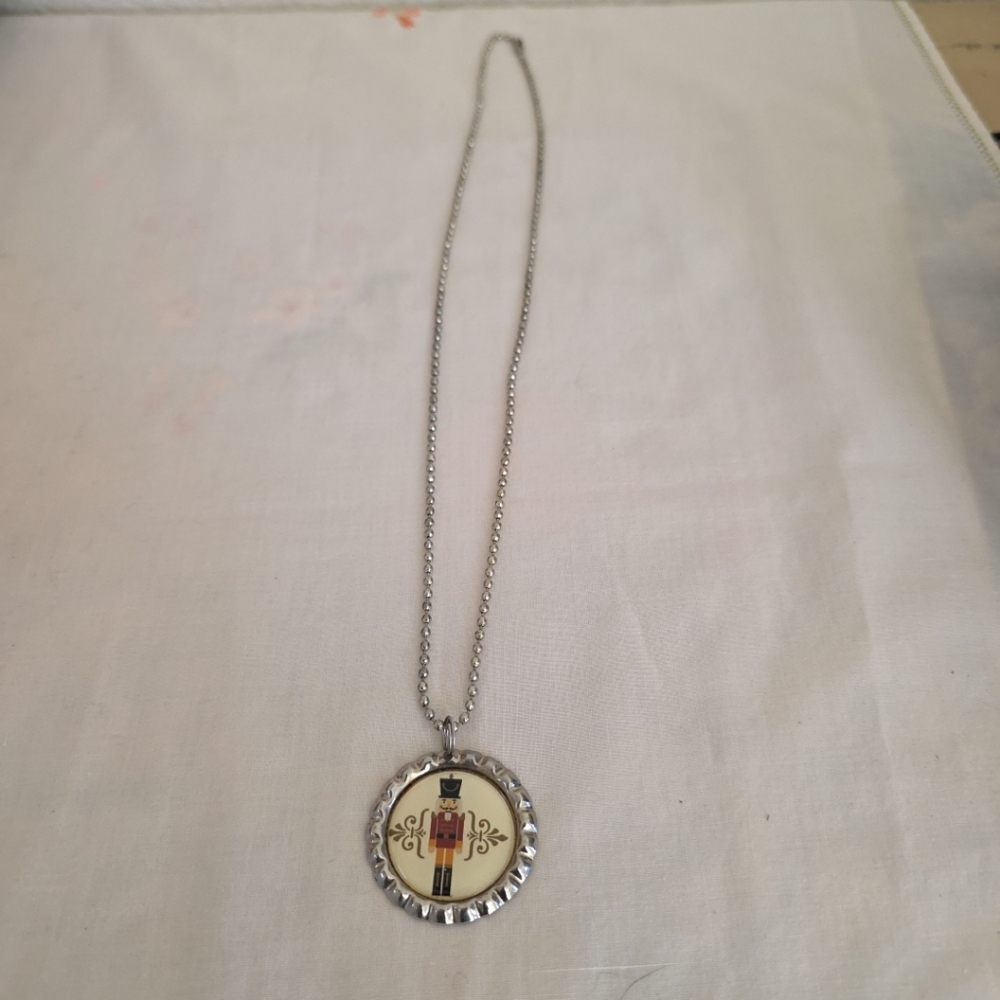 Nutcracker Necklace With Bottle Cap Look And 24 Inch Beaded Chain